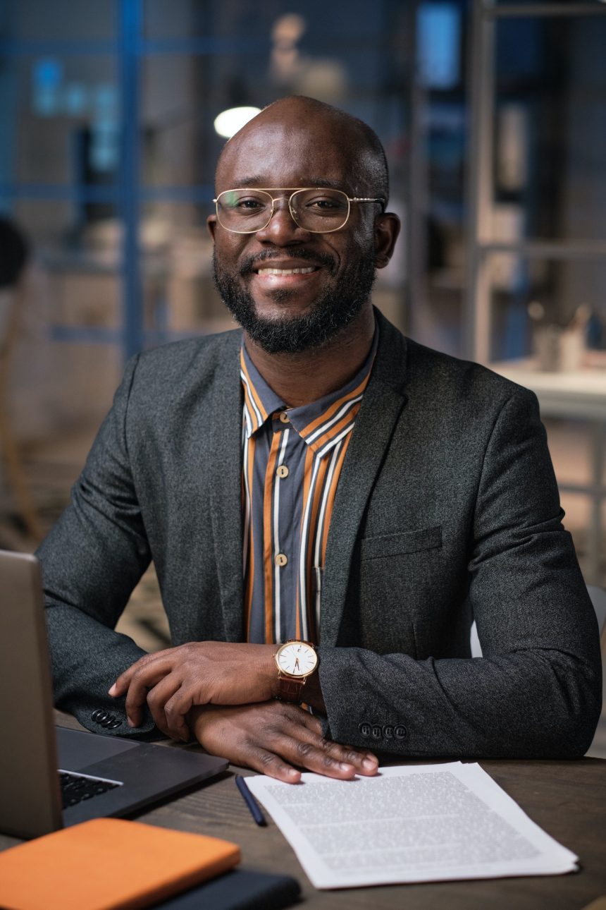 A man on suit smiling